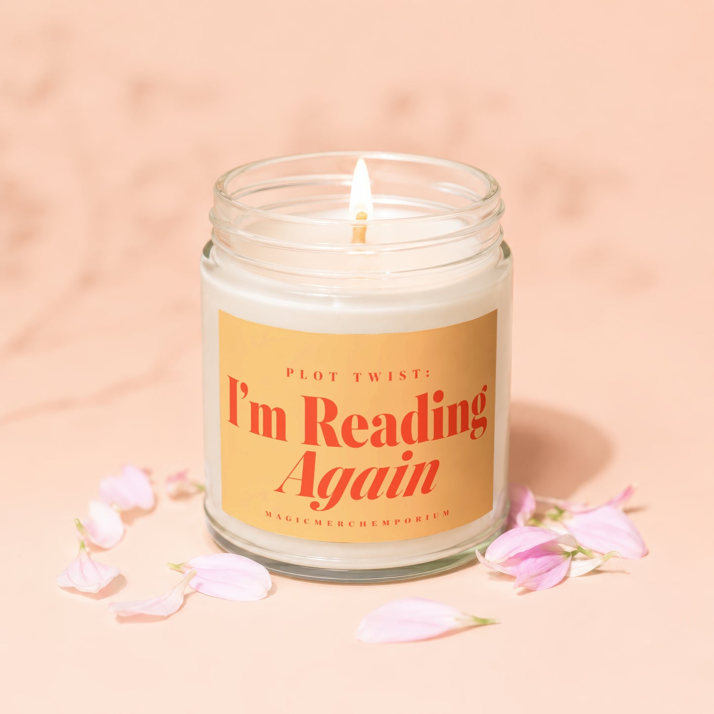 A lit candle in a glass jar with text "PLOT TWIST: I'm Reading Again".