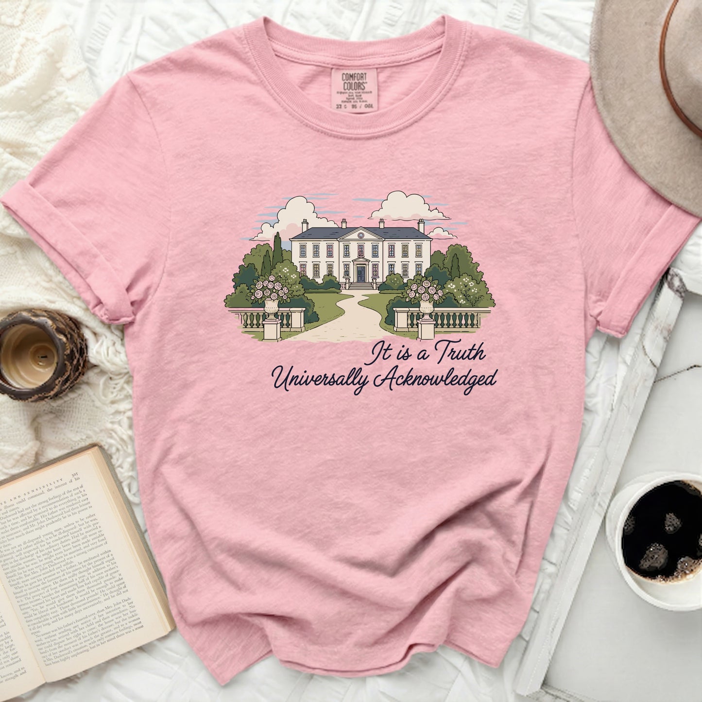 Pink Comfort Colors t-shirt with illustration of a manor and text "It is a Truth Universally Acknowledged".