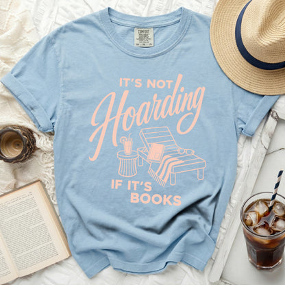 Light blue t-shirt with "It's not hoarding if it's books" slogan.