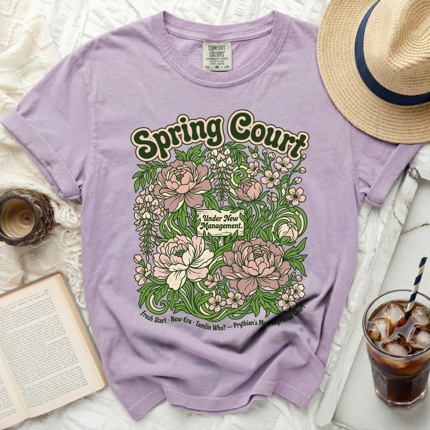 Lavender Comfort Colors t-shirt with "Spring Court Under New Management" floral graphic.