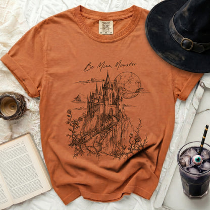 Orange Comfort Colors t-shirt with castle, moon, and "Be Mine, Monster" text.