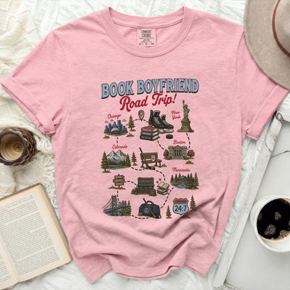 Pink t-shirt with "Book Boyfriend Road Trip" graphic featuring city icons.