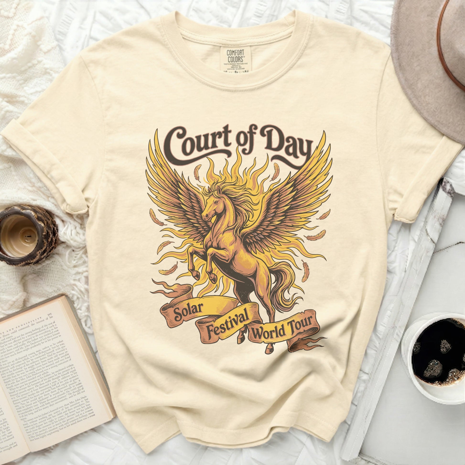 Cream t-shirt with golden winged horse and "Court of Day Solar Festival World Tour" text.