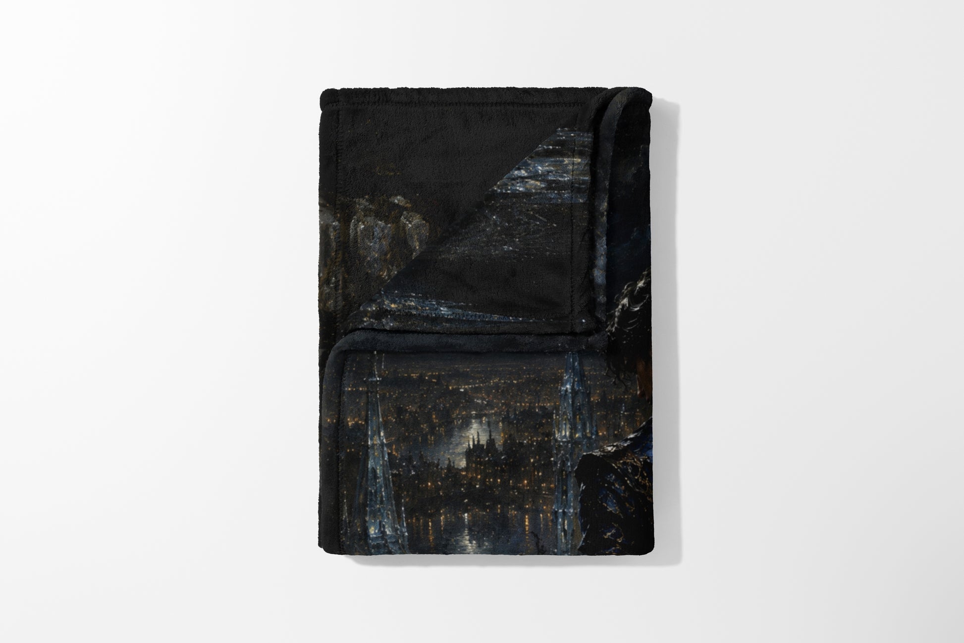 Folded black blanket with a dark cityscape and illuminated Eiffel Tower print.