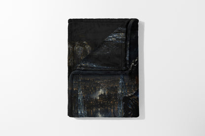 Folded black blanket with a dark cityscape and illuminated Eiffel Tower print.