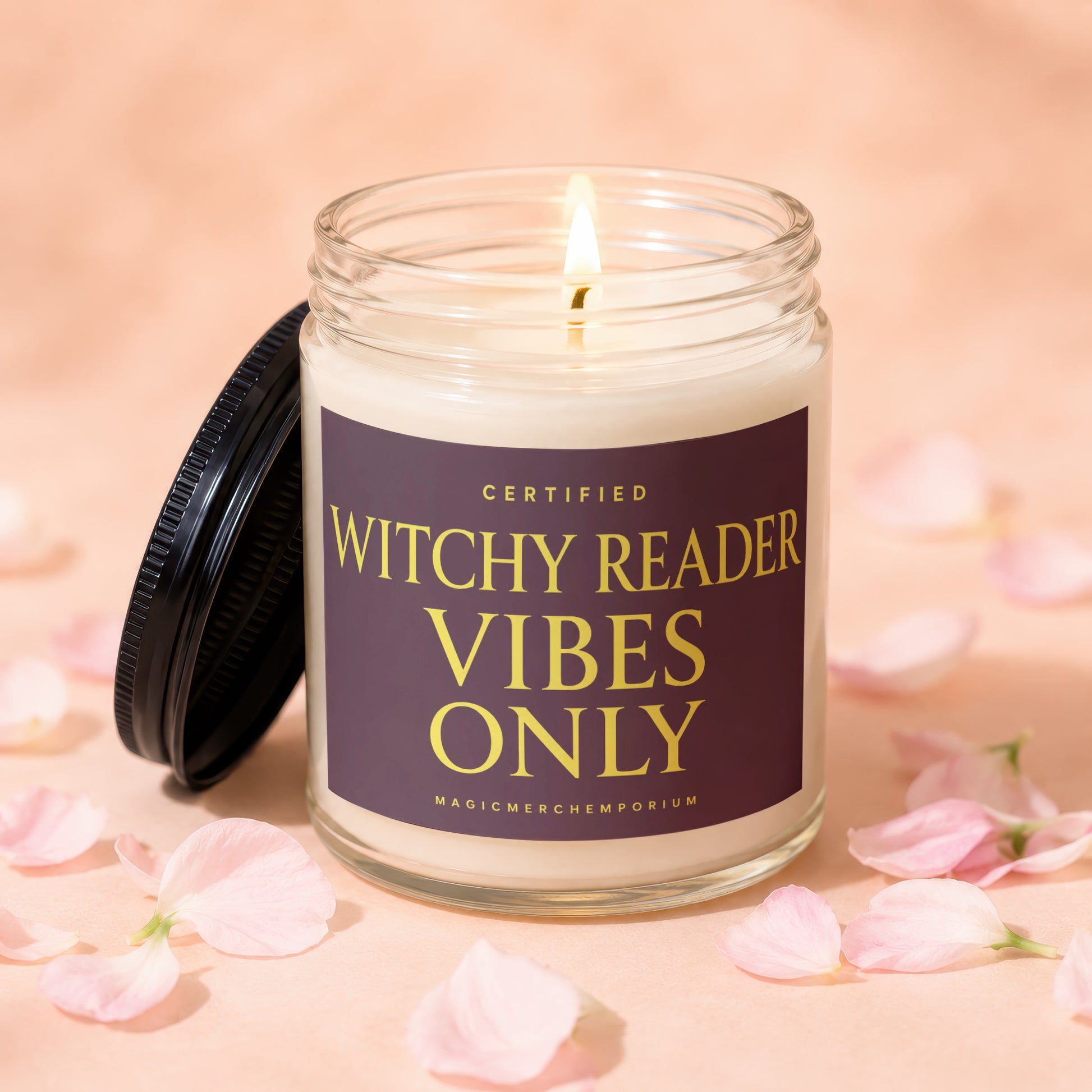 Glass candle with lit wick and lid beside it, reading "Certified Witchy Reader Vibes Only".