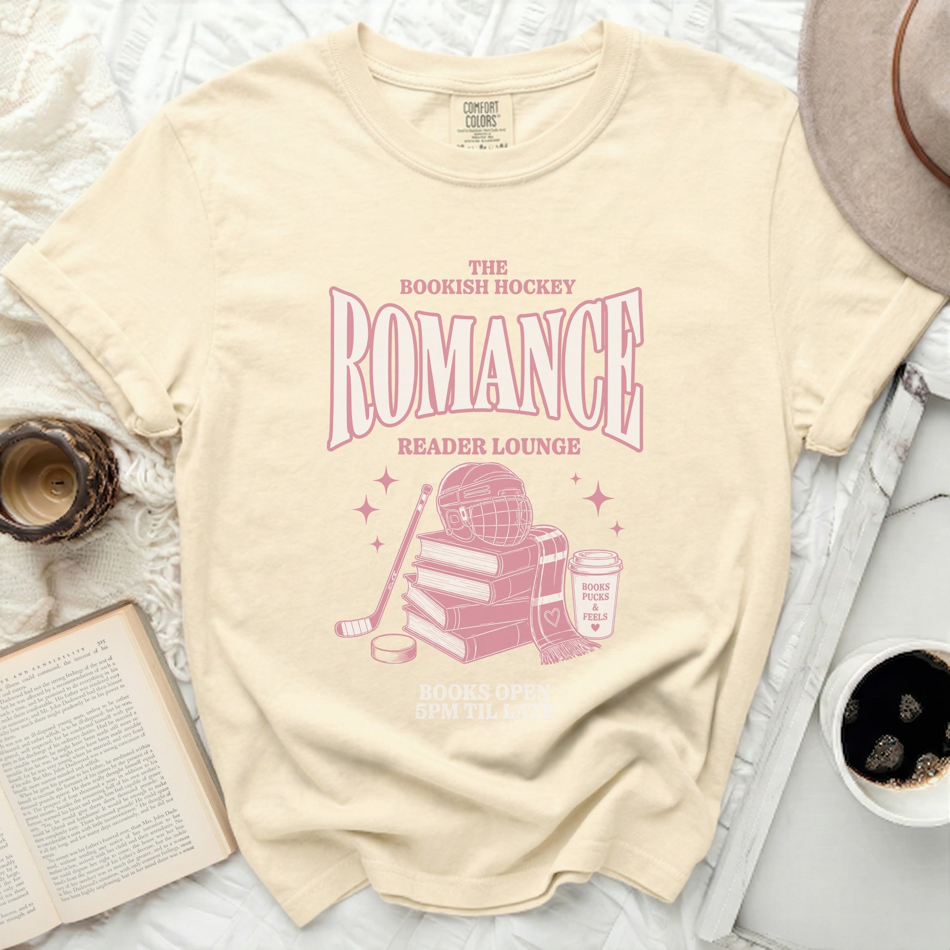 T-shirt with pink text "The Bookish Hockey Romance Reader Lounge" and hockey elements.