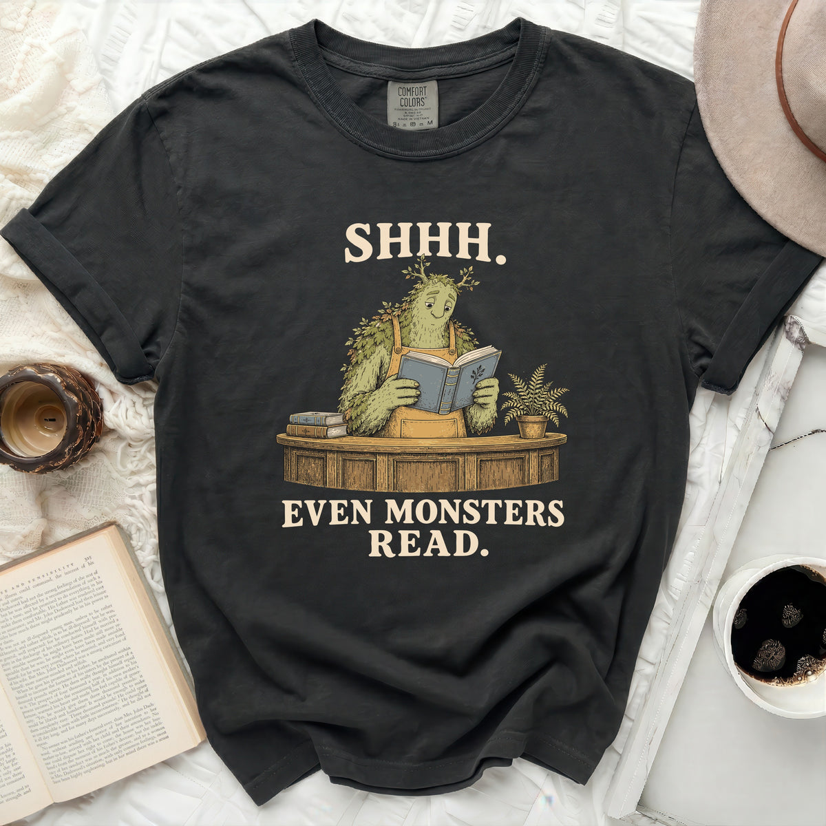 T-shirt with "SHHH. EVEN MONSTERS READ." text and monster illustration.