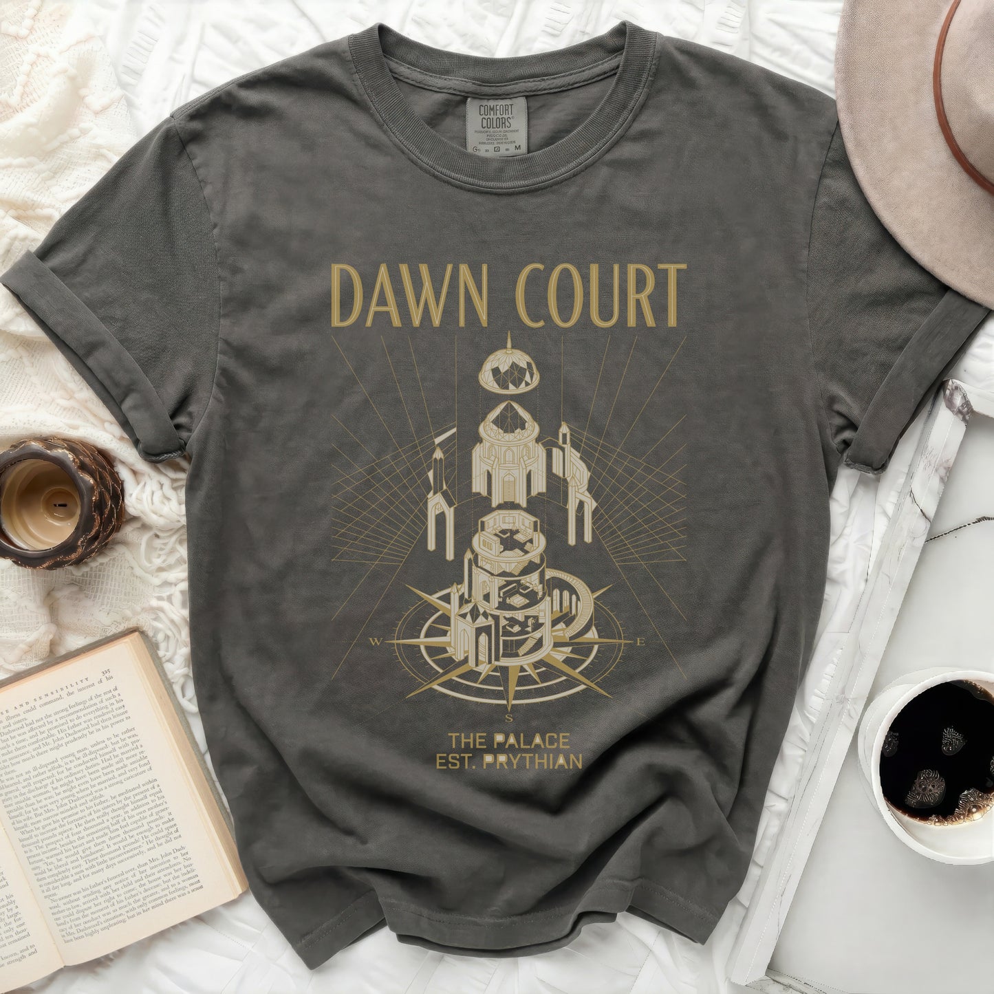 Dark grey t-shirt with gold graphic of a tower, compass, and "Dawn Court The Palace Est. Prythian".