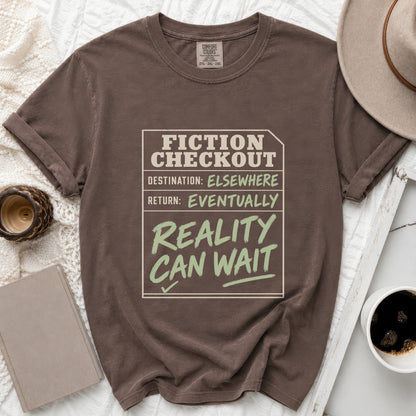 Brown t-shirt with "FICTION CHECKOUT DESTINATION: ELSEWHERE RETURN: EVENTUALLY REALITY CAN WAIT" text.