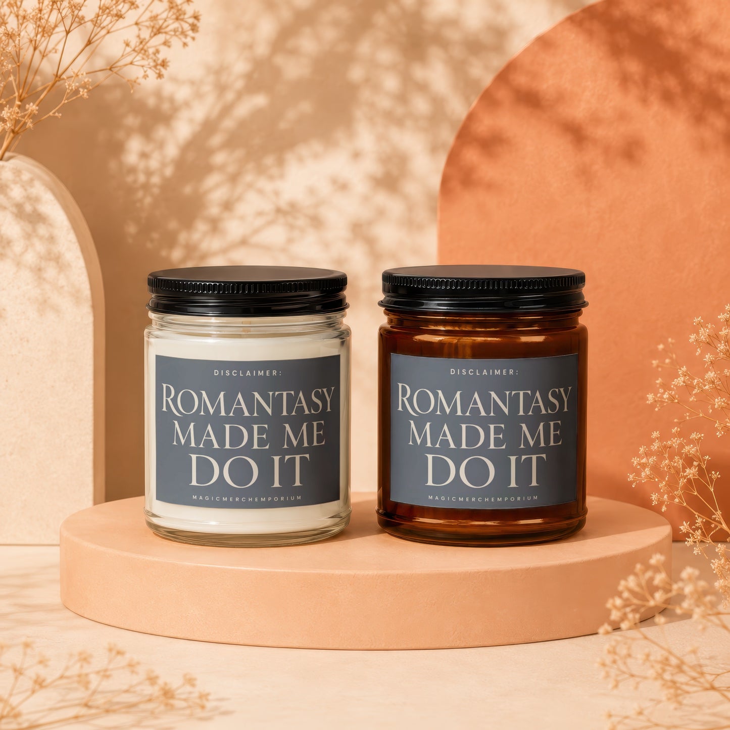 Two candles sit on a peach pedestal, each with "ROMANTASY MADE ME DO IT" label.
