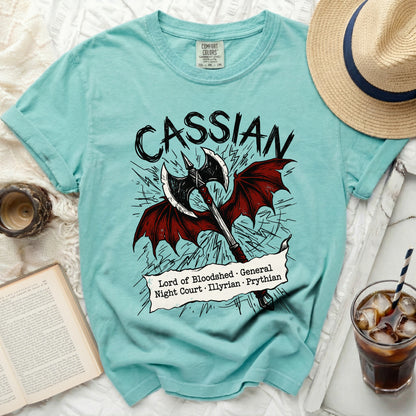 Teal t-shirt with "Cassian" and axe graphic, listing titles.