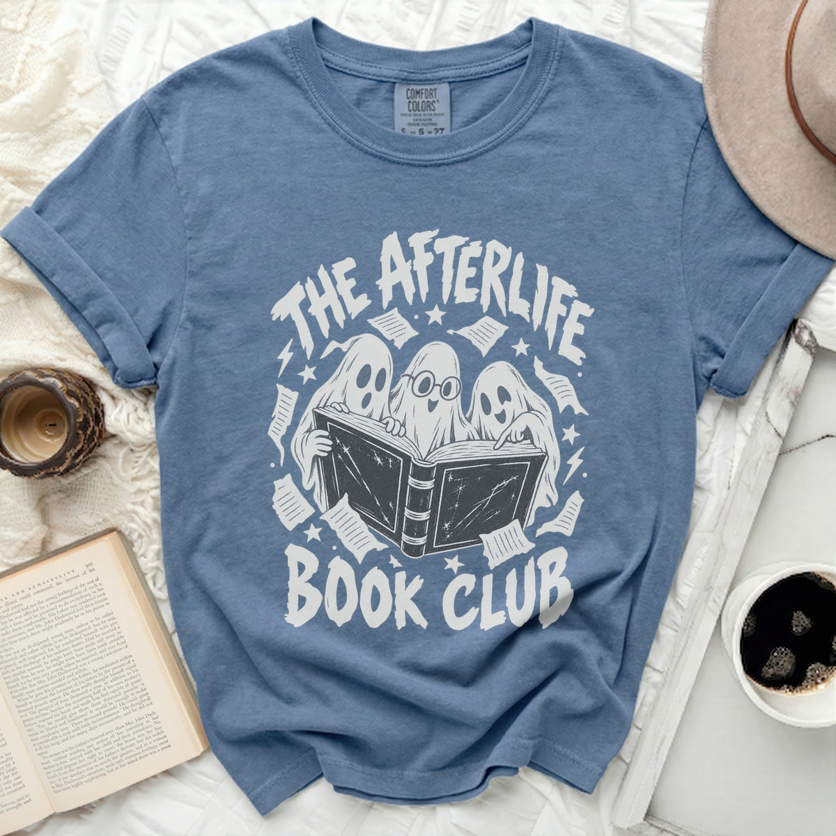 The afterlife book club t-shirt features three ghosts reading a book.