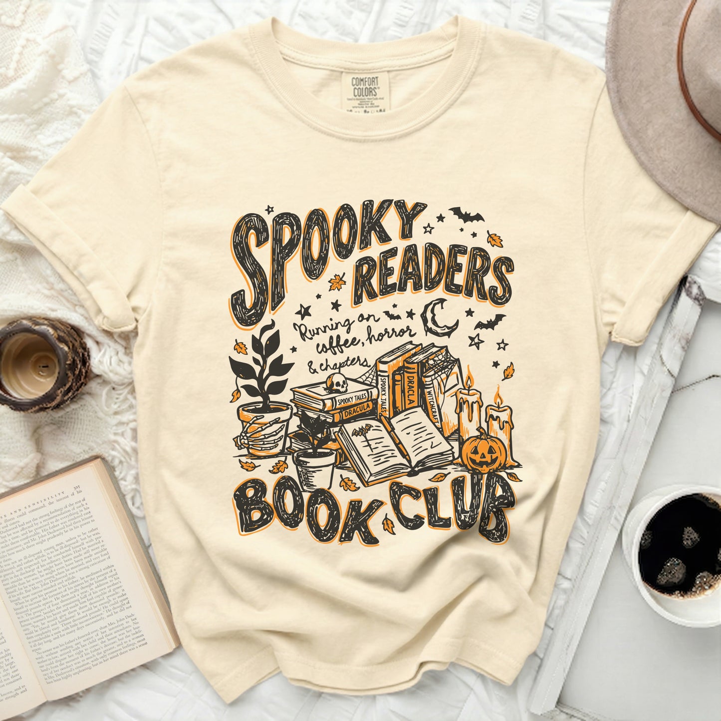 Cream t-shirt with "Spooky Readers Book Club" and Halloween illustrations.