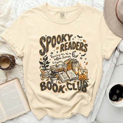 Cream t-shirt with "Spooky Readers Book Club" and Halloween illustrations.