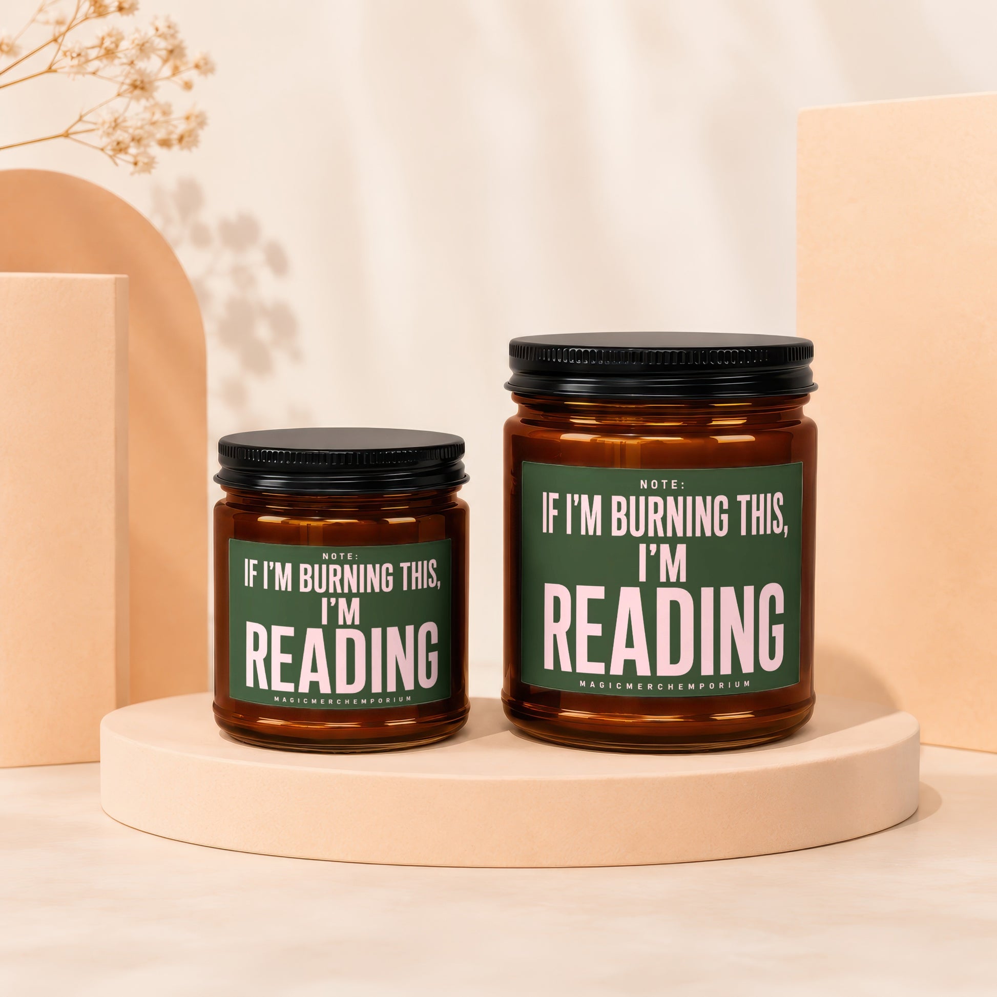 Two amber glass candles with "If I'm Burning This, I'm Reading" text.