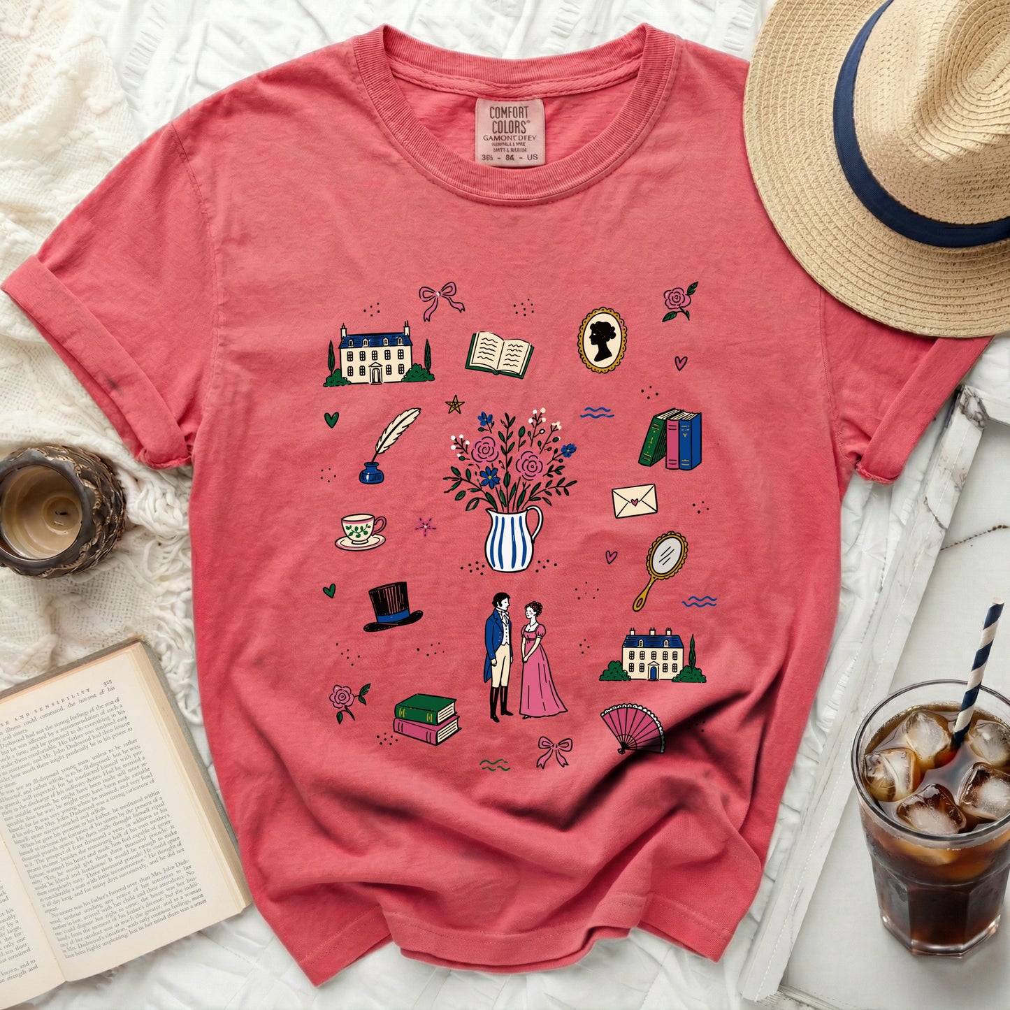 Coral t-shirt with Regency-themed illustrations and "Comfort Colors" tag.