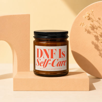 Amber glass candle with label reading "DNF Is Self-Care."