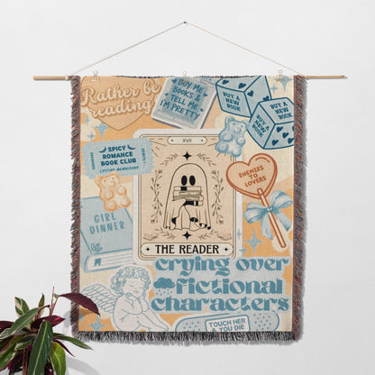 The image is a colorful and whimsical tapestry featuring various elements related to reading and storytelling, including a tarot card, a teddy bear, a book, and a heart.