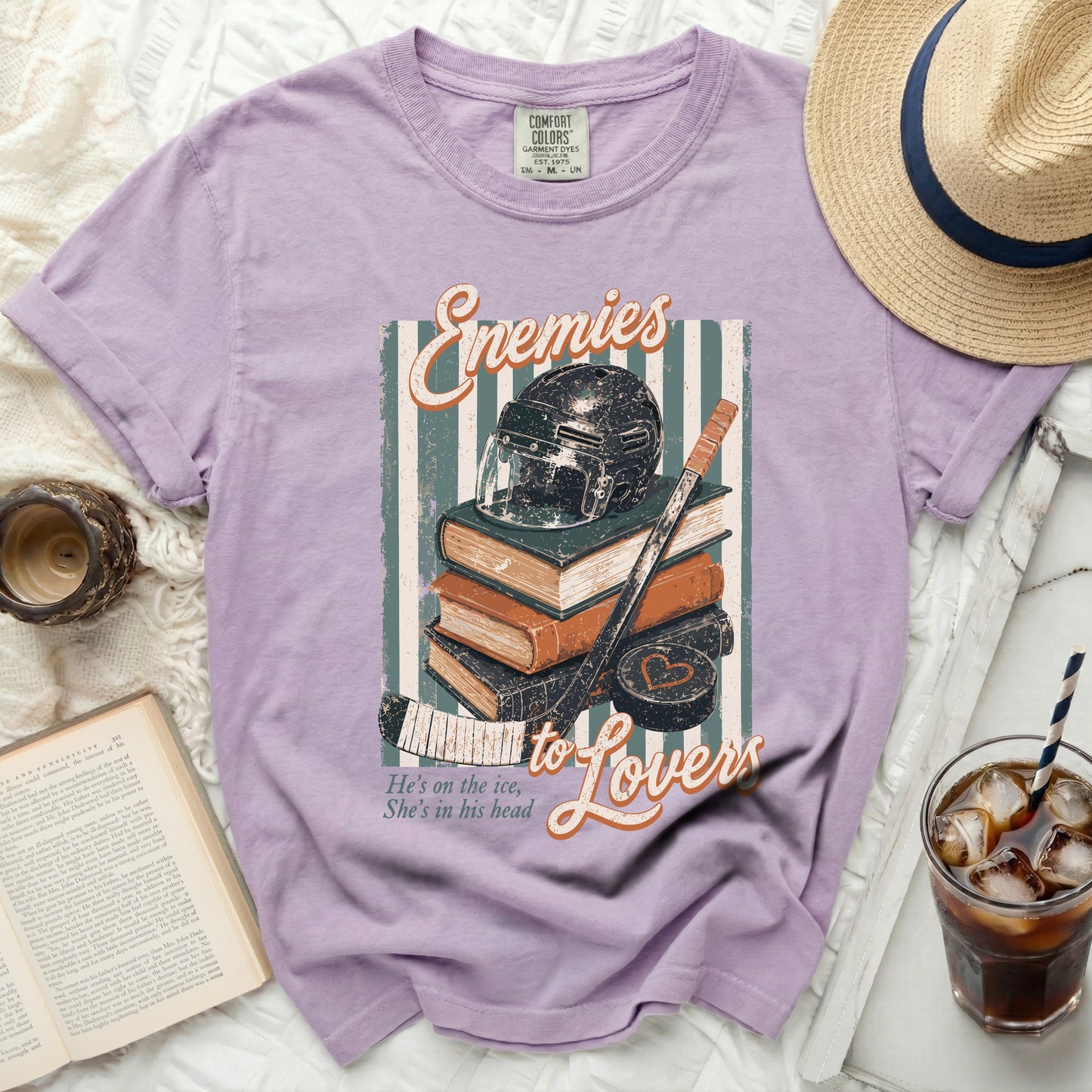 Purple t-shirt with "Enemies to Lovers" text and hockey imagery.
