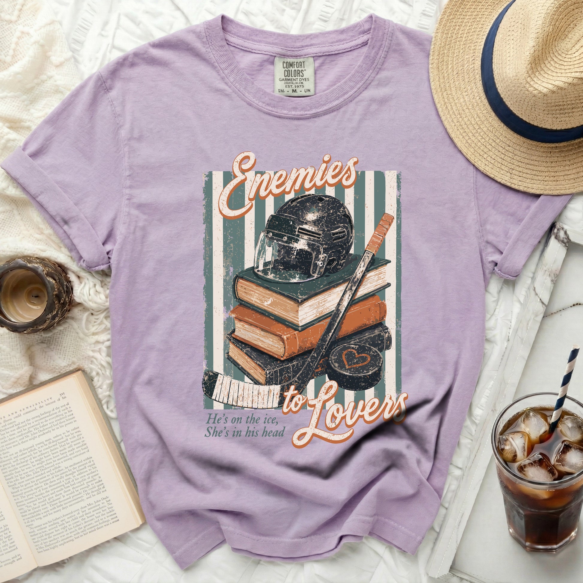 Purple t-shirt with "Enemies to Lovers" text and hockey imagery.