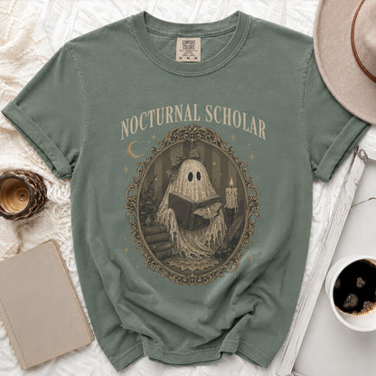 Green t-shirt with "Nocturnal Scholar" text and a ghost reading a book design.
