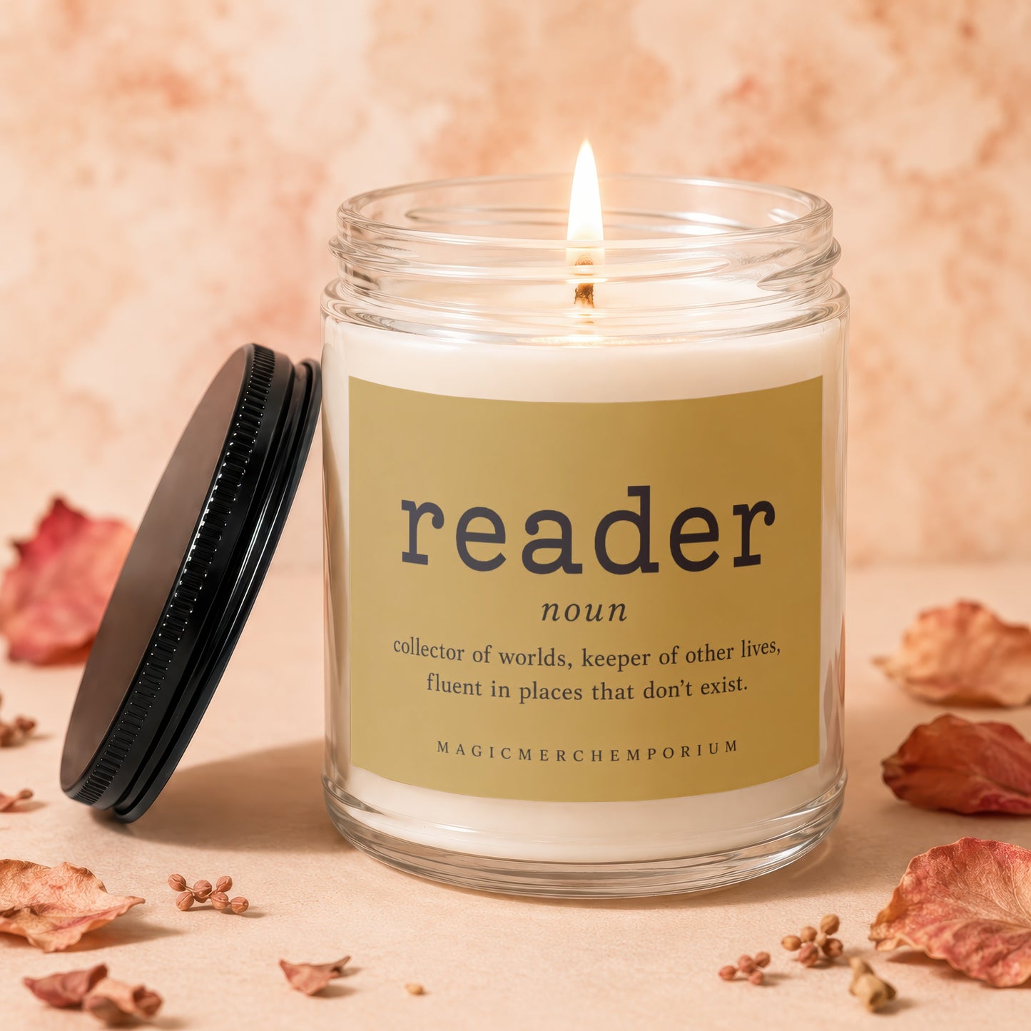 Lit candle with "reader" definition label and black lid beside it.