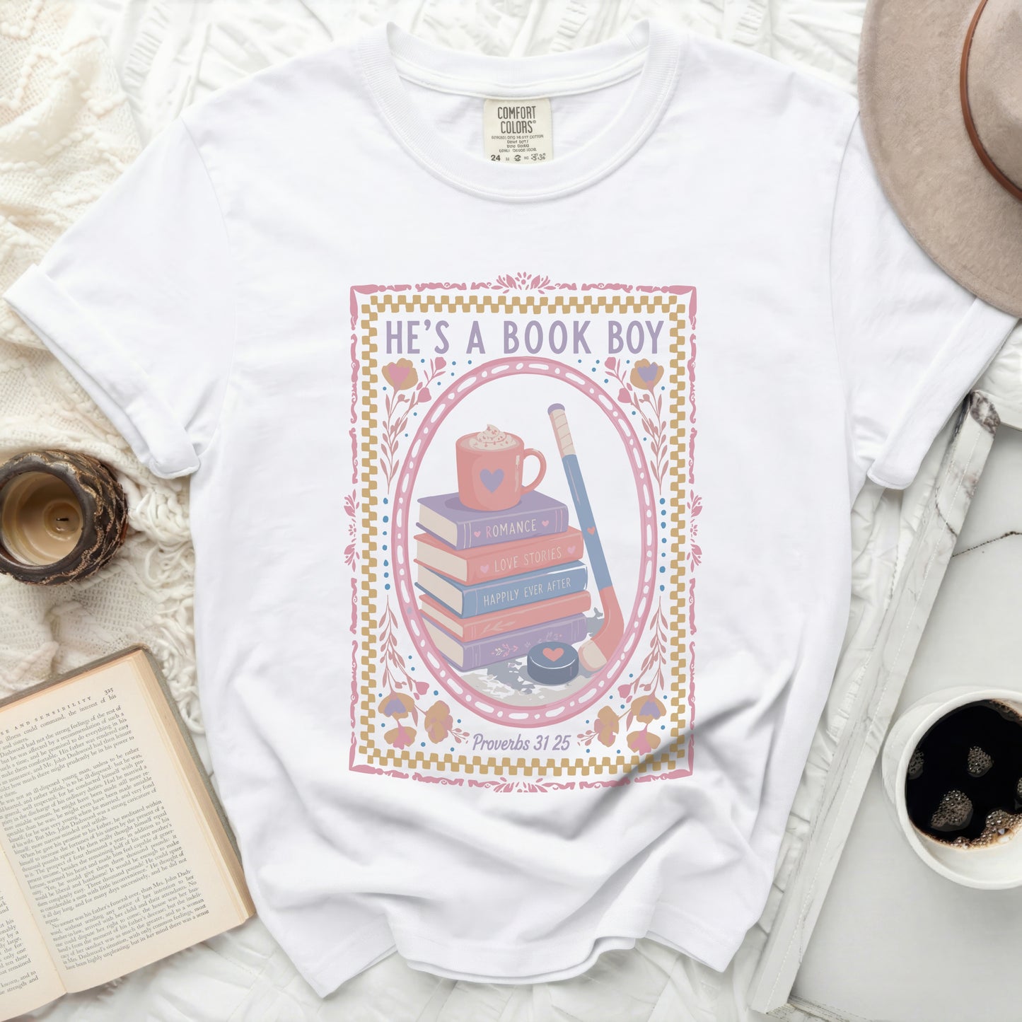 White t-shirt with "HE'S A BOOK BOY" and reading-themed illustration.