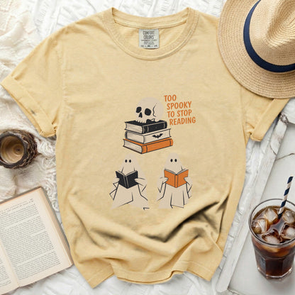 Yellow t-shirt with skull, books, ghosts, and "Too Spooky to Stop Reading" text.
