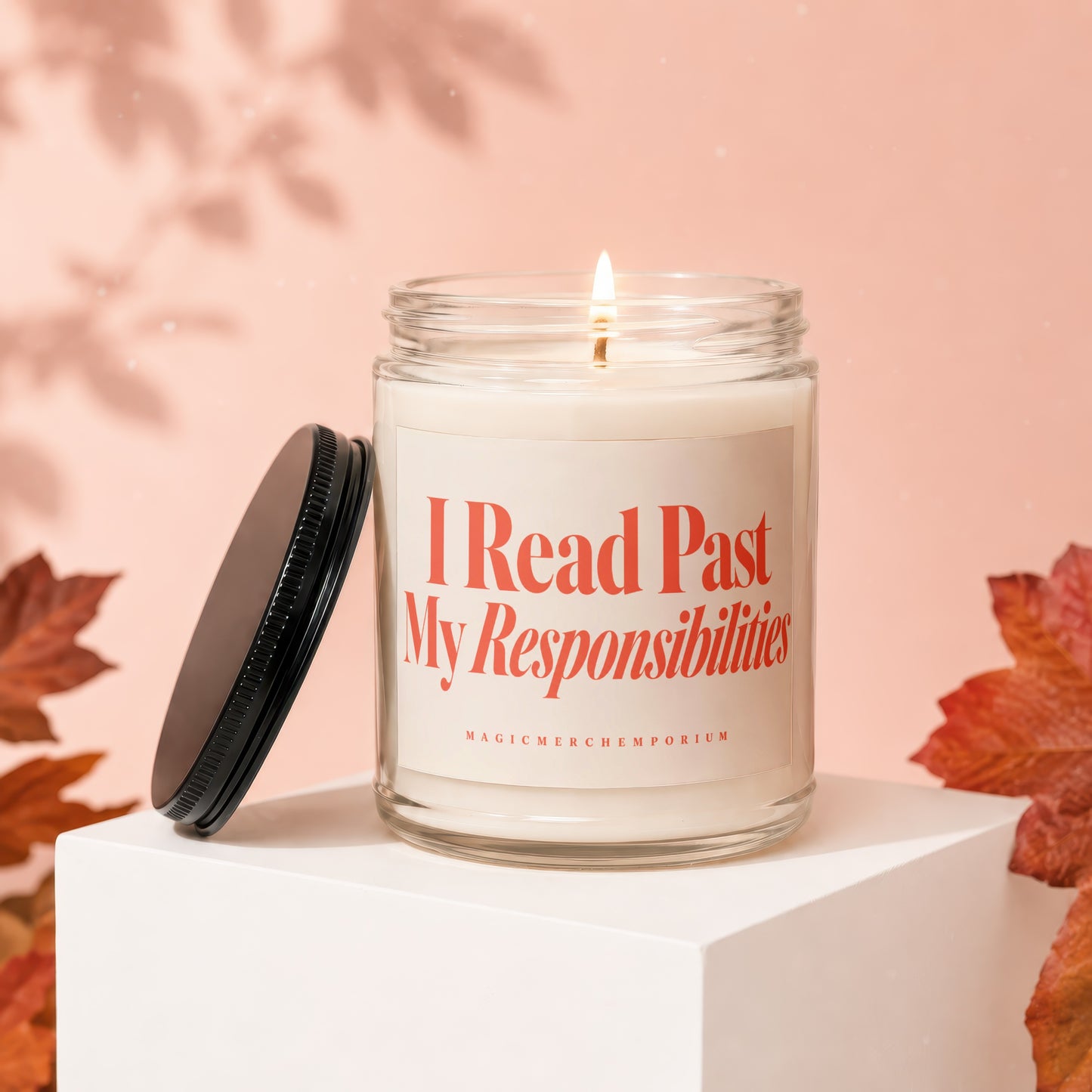 Lit candle in a glass jar with the text "I Read Past My Responsibilities"