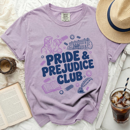 Purple t-shirt with "Pride & Prejudice Club" graphic, book, and manor.