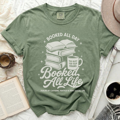 Green t-shirt with stack of books, coffee mug, and text.