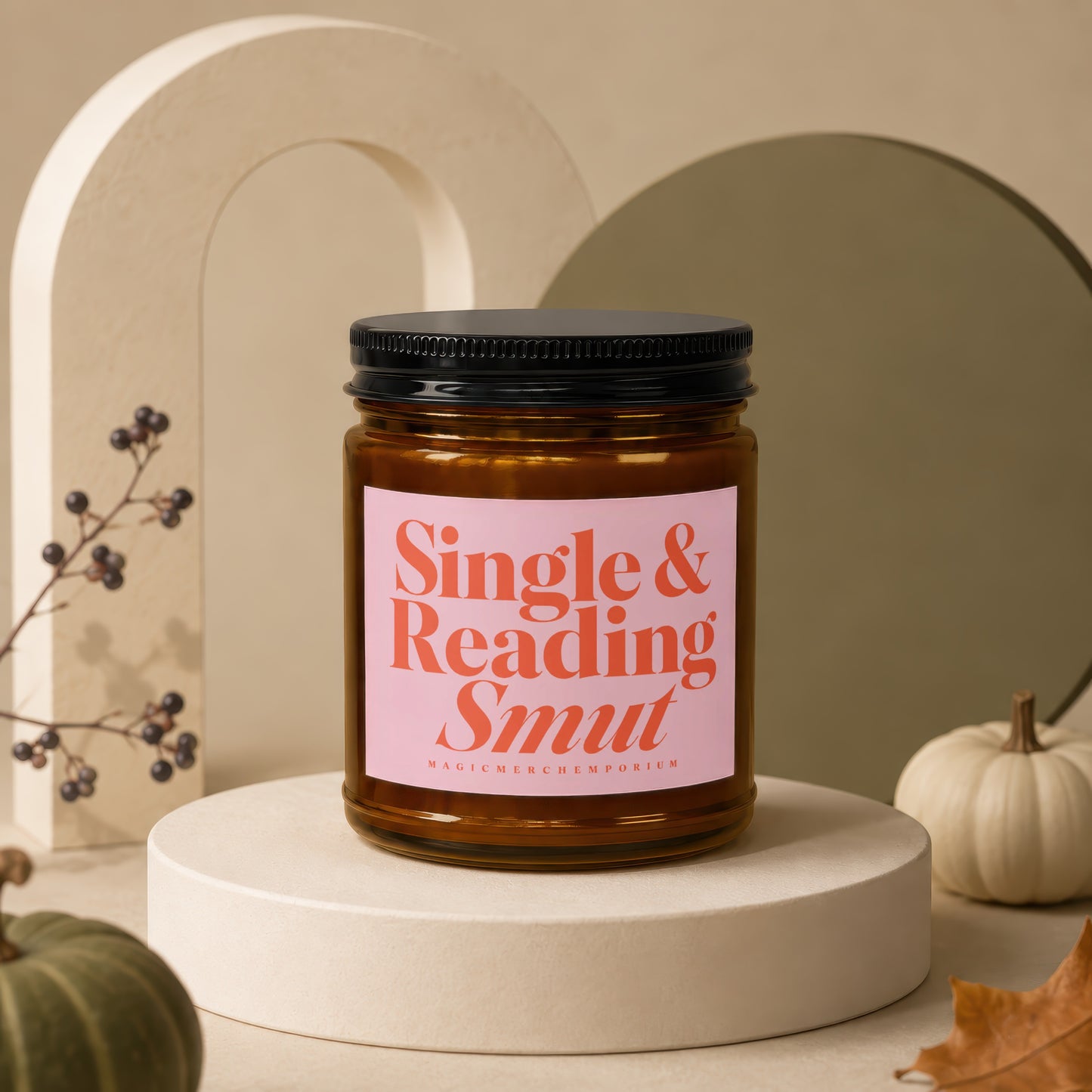 Amber jar candle with pink label reading "Single & Reading Smut."