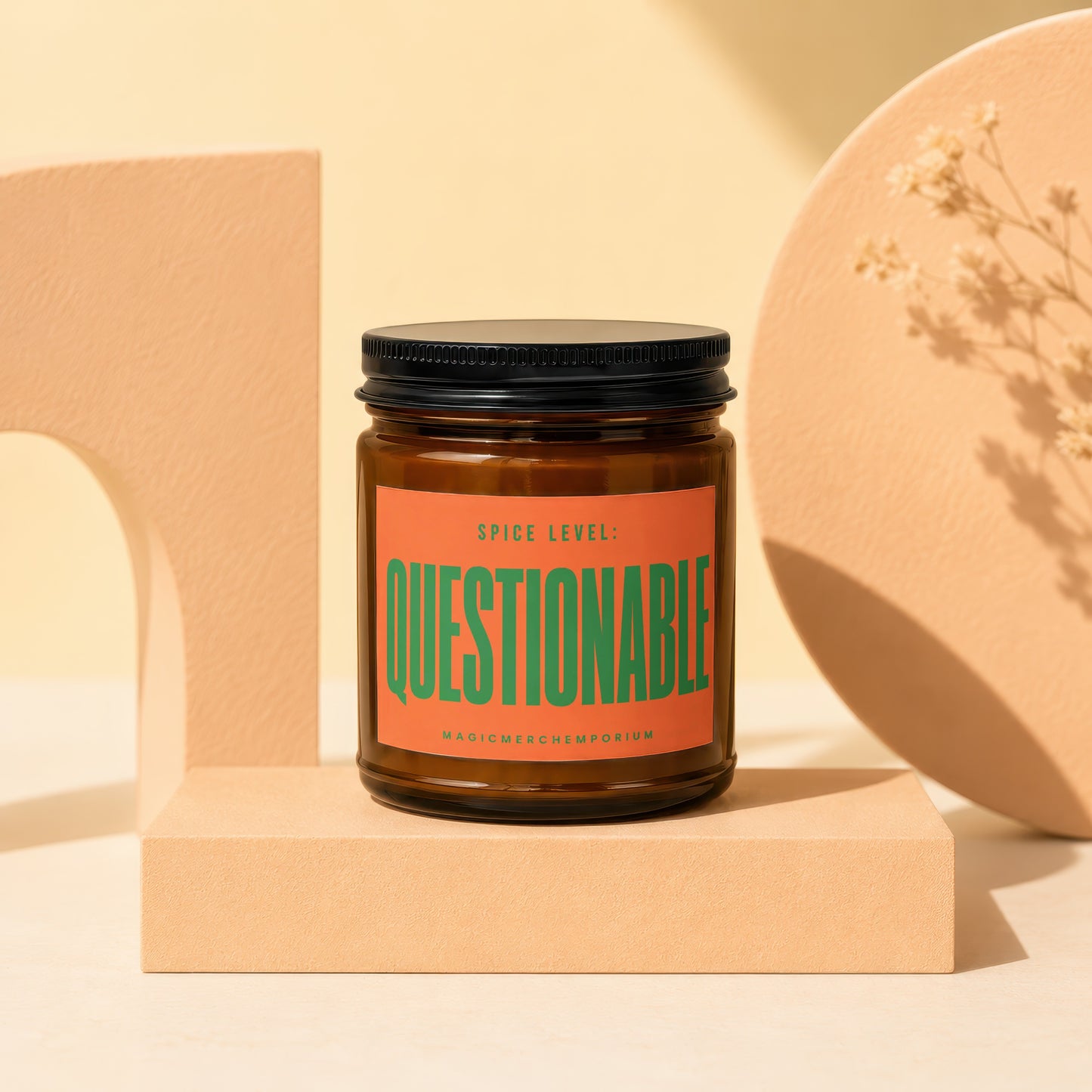 Amber jar candle with orange label reading "Spice Level: Questionable" and "MagicMerchEmporium".