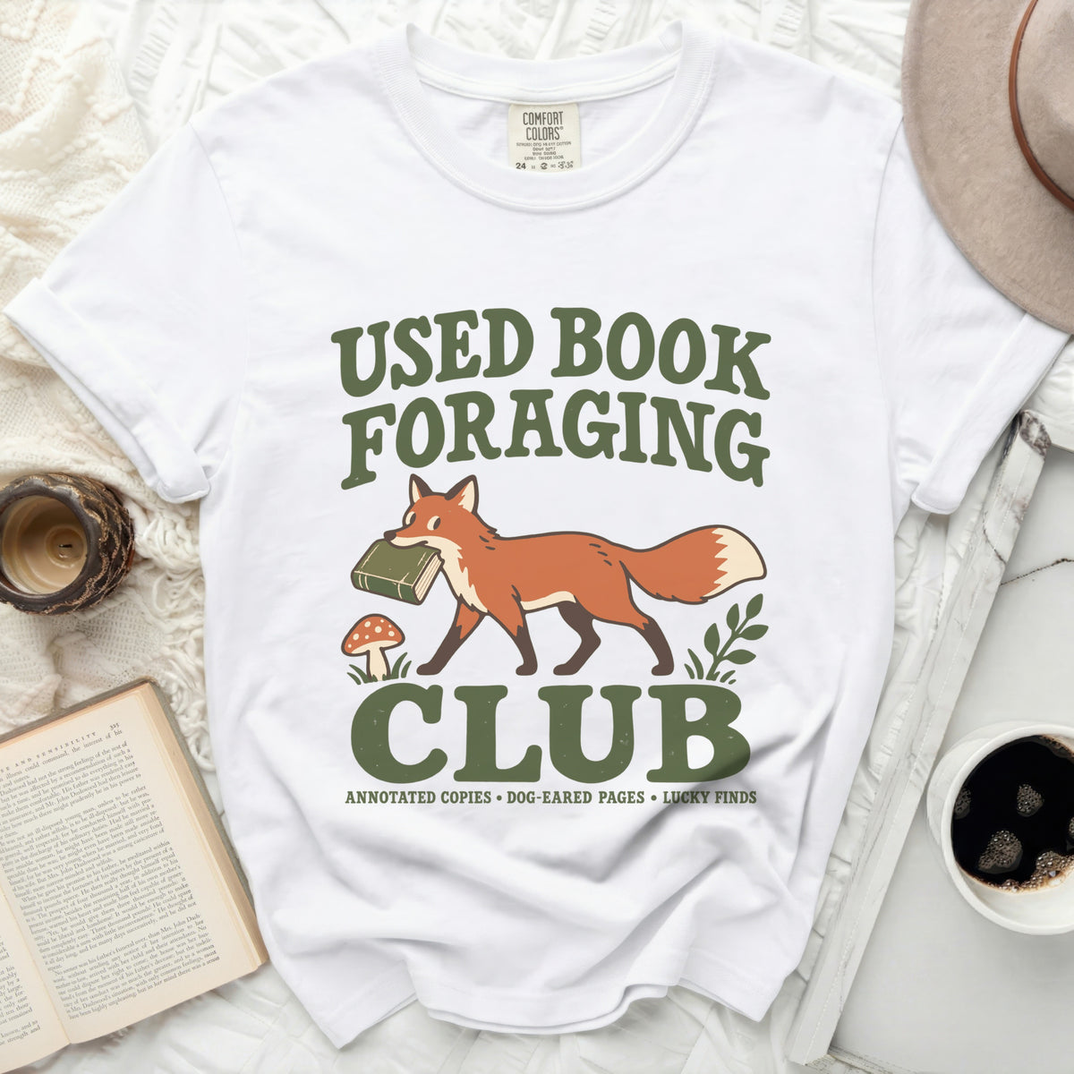 White t-shirt with "Used Book Foraging Club" graphic, featuring a fox carrying a book.