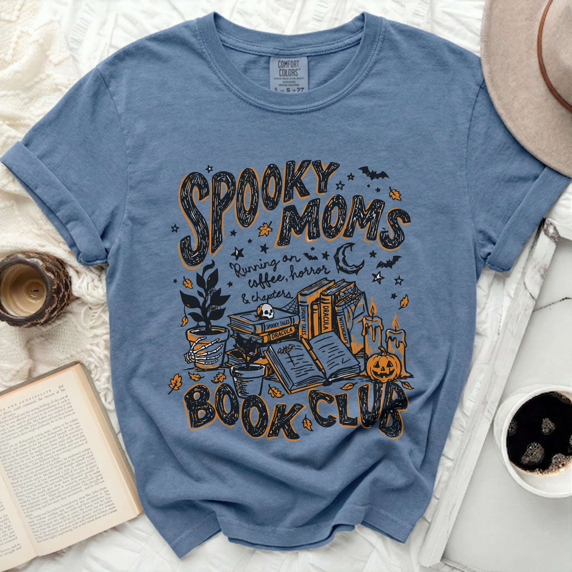 Blue t-shirt with "Spooky Moms Running on coffee, horror & chapters Book Club" graphic.