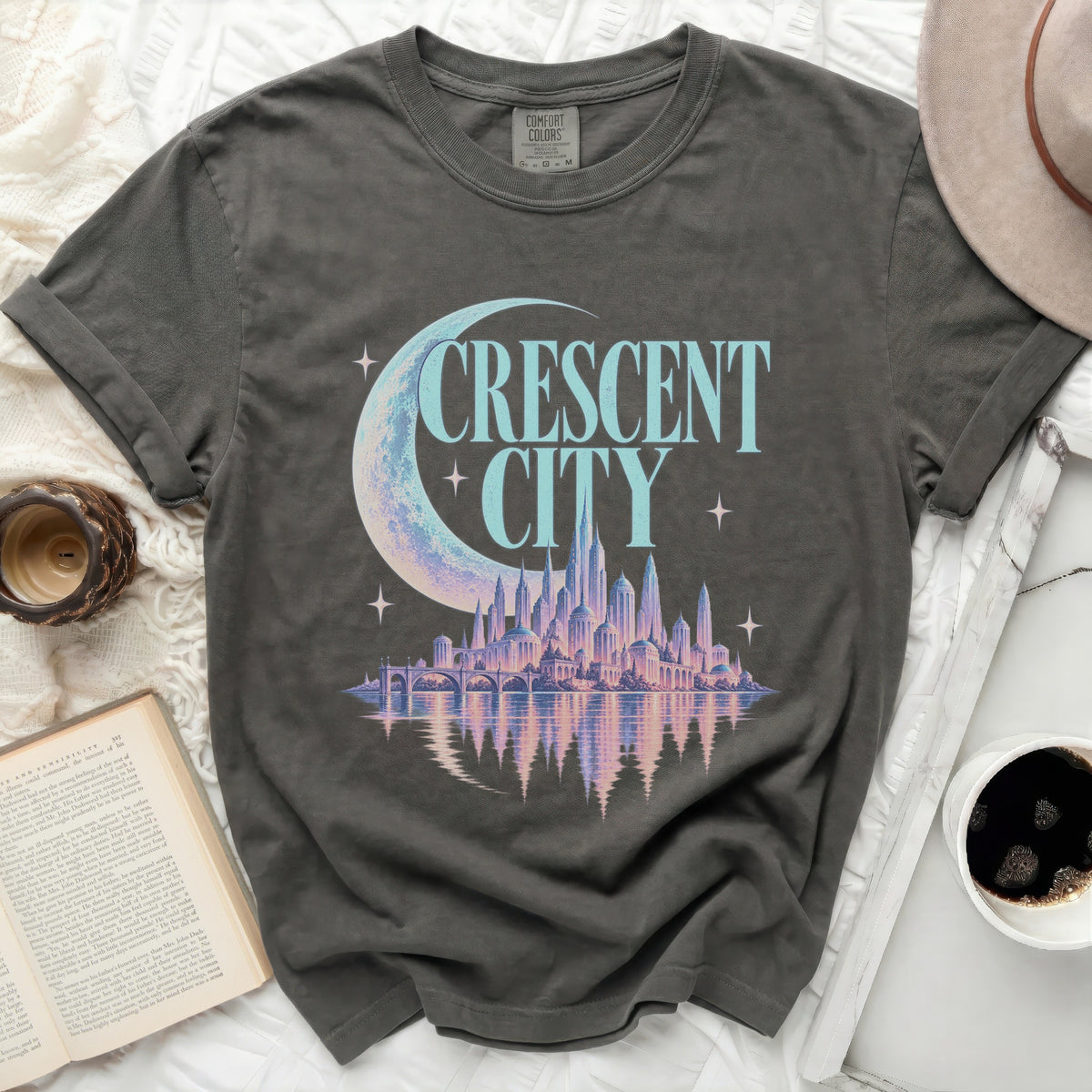 Grey t-shirt with "CRESCENT CITY" text, crescent moon, and fantasy city graphic.