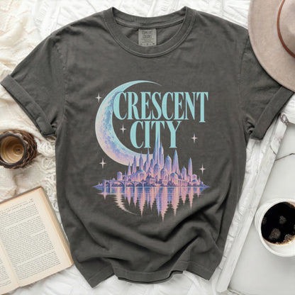 Grey t-shirt with "CRESCENT CITY" text, crescent moon, and fantasy city graphic.