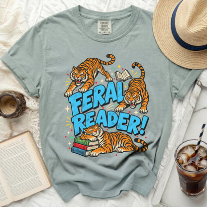 T-shirt with "Feral Reader" text and three tigers, one sleeping on books.