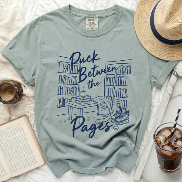 Puck Between the Pages Hockey Tee in Bay