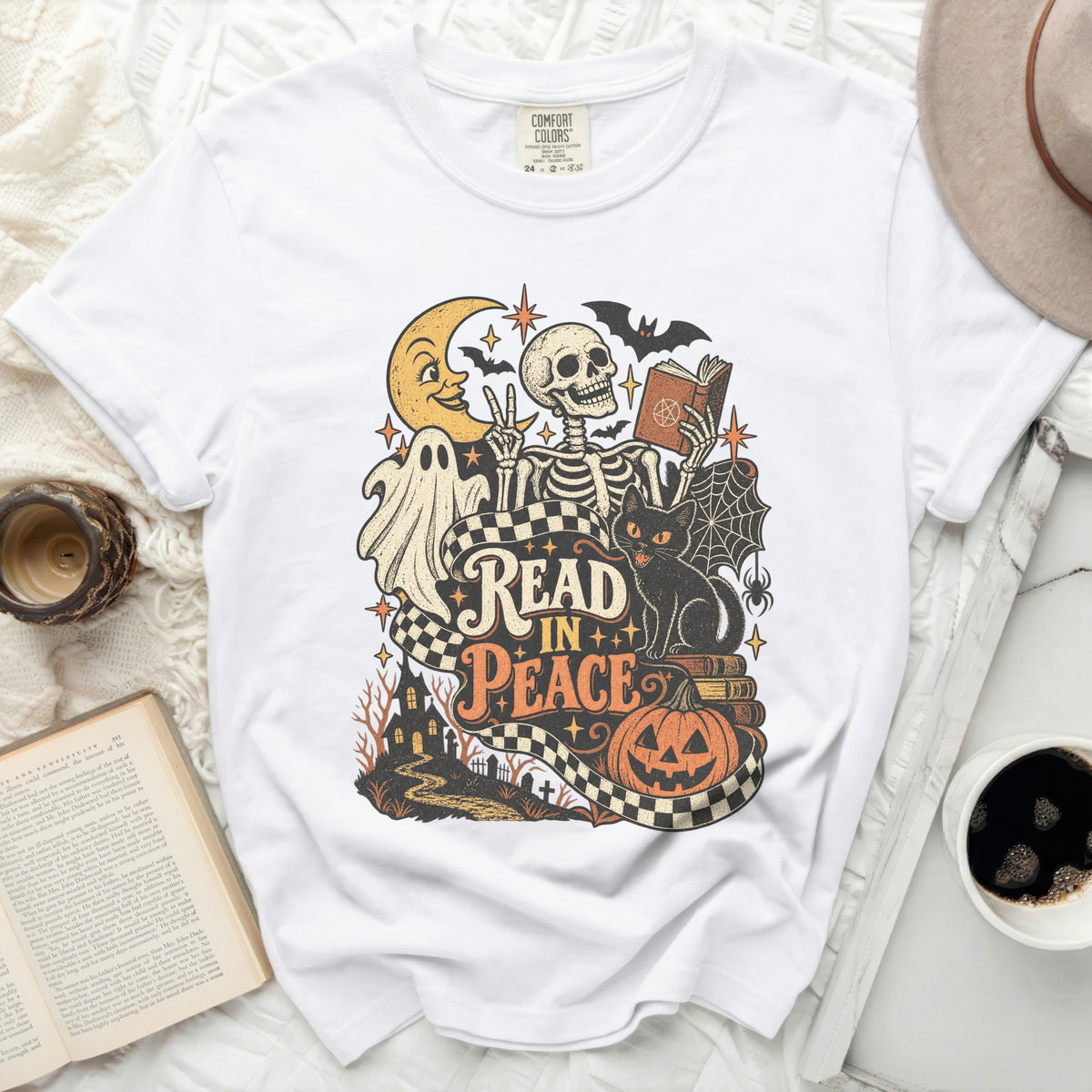 White t-shirt with a Halloween-themed graphic reading "Read In Peace".