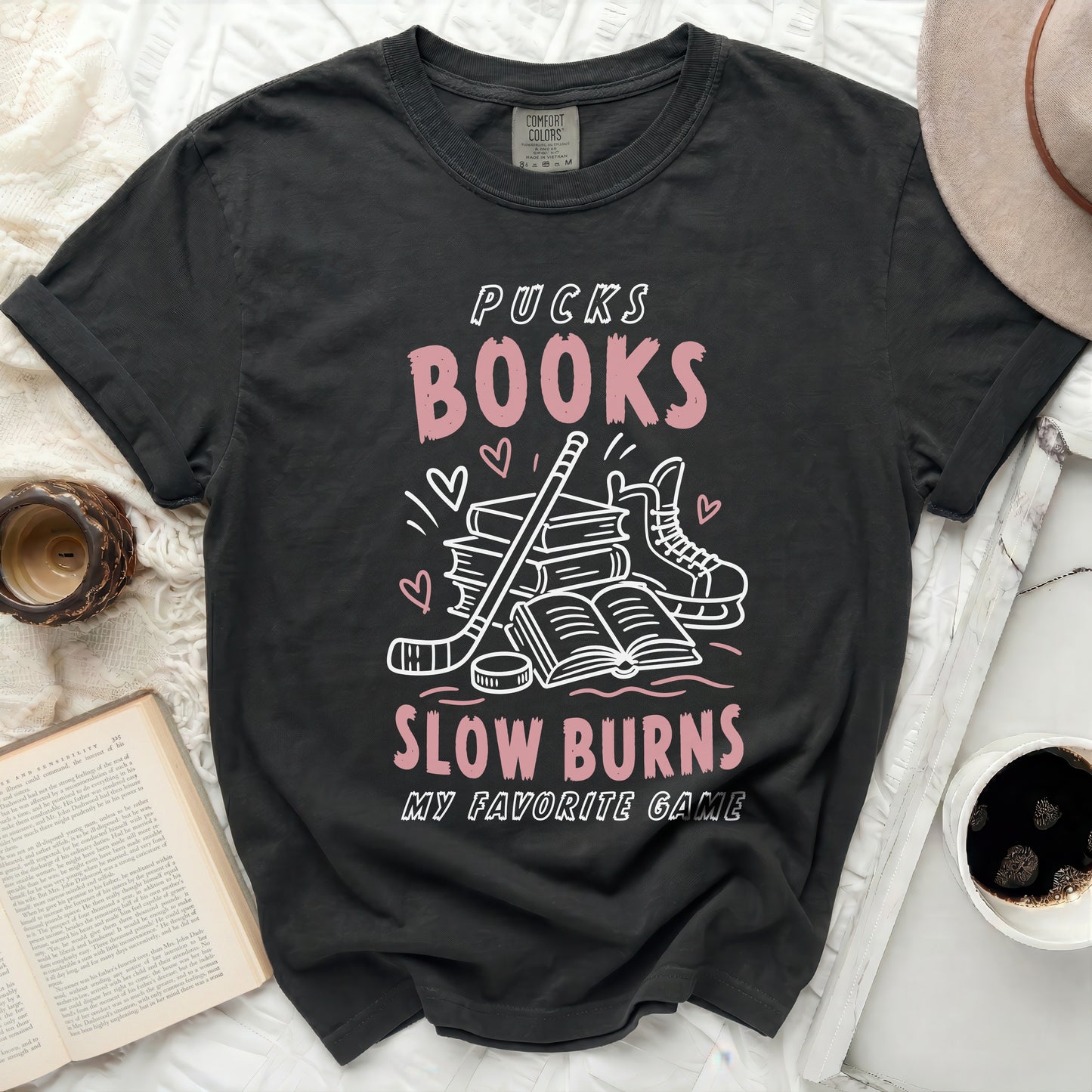 Black t-shirt with "Pucks Books Slow Burns My Favorite Game" text and hockey graphics.