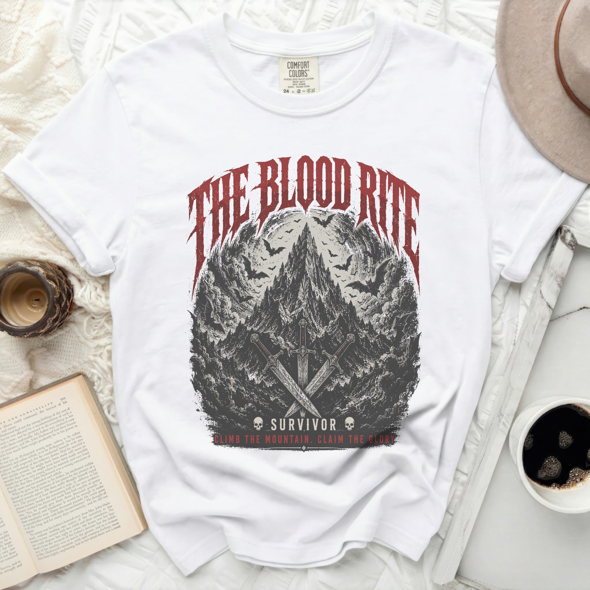 White t-shirt with "The Blood Rite Survivor" graphic and swords.