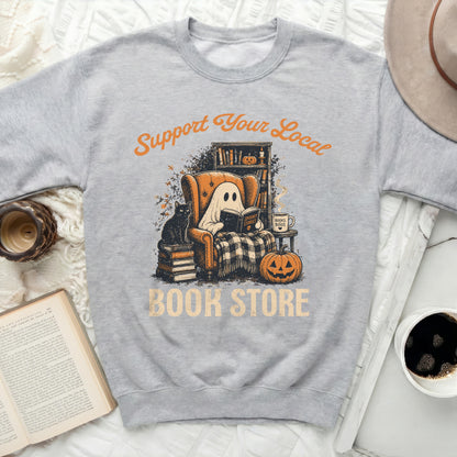 Grey sweatshirt featuring a ghost reading in a chair with text.