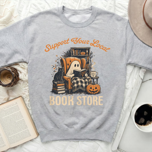 Grey sweatshirt featuring a ghost reading in a chair with text.