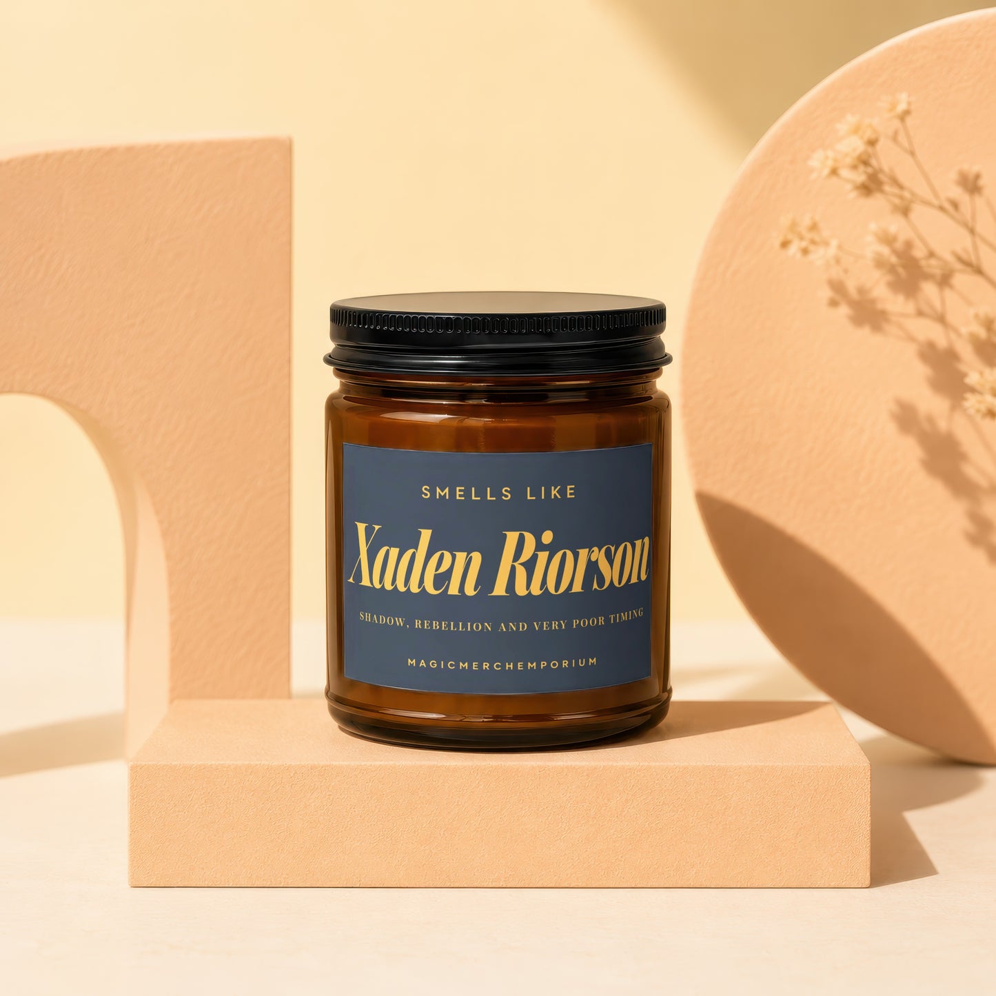 Amber jar candle with a dark blue label reading "Xaden Riorson, Shadow, Rebellion and Very Poor Timing."