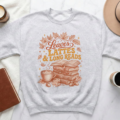 Light grey sweatshirt with "Leaves, Lattes & Long Reads" graphic and autumn illustrations.