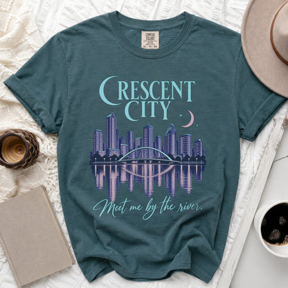 Teal t-shirt with "Crescent City" graphic and river reflection.