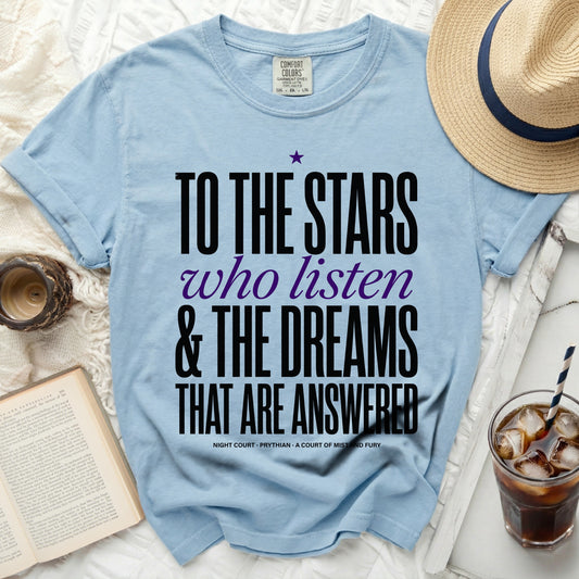 Light blue t-shirt with black and purple text "To the Stars who listen & the dreams that are answered".