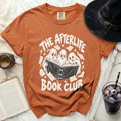 Orange t-shirt with ghosts reading a book and text "THE AFTERLIFE BOOK CLUB".